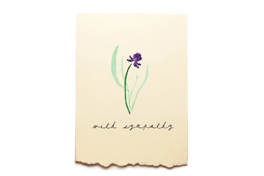 Card with a purple flower illustration and 'with sympathy' text on a beige background