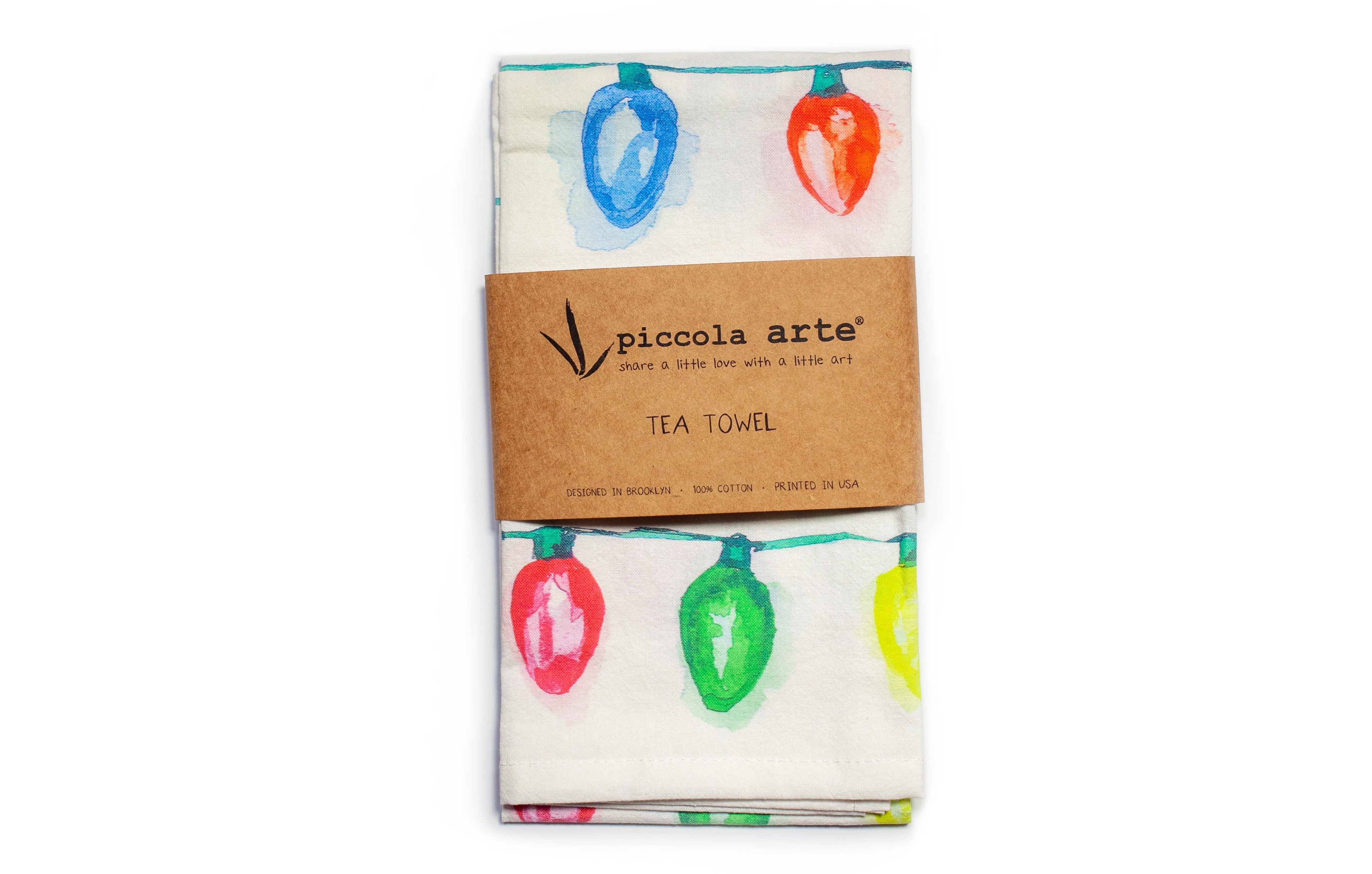 Tea towel with colorful light bulb pattern and 'piccola atte' branding on a white background