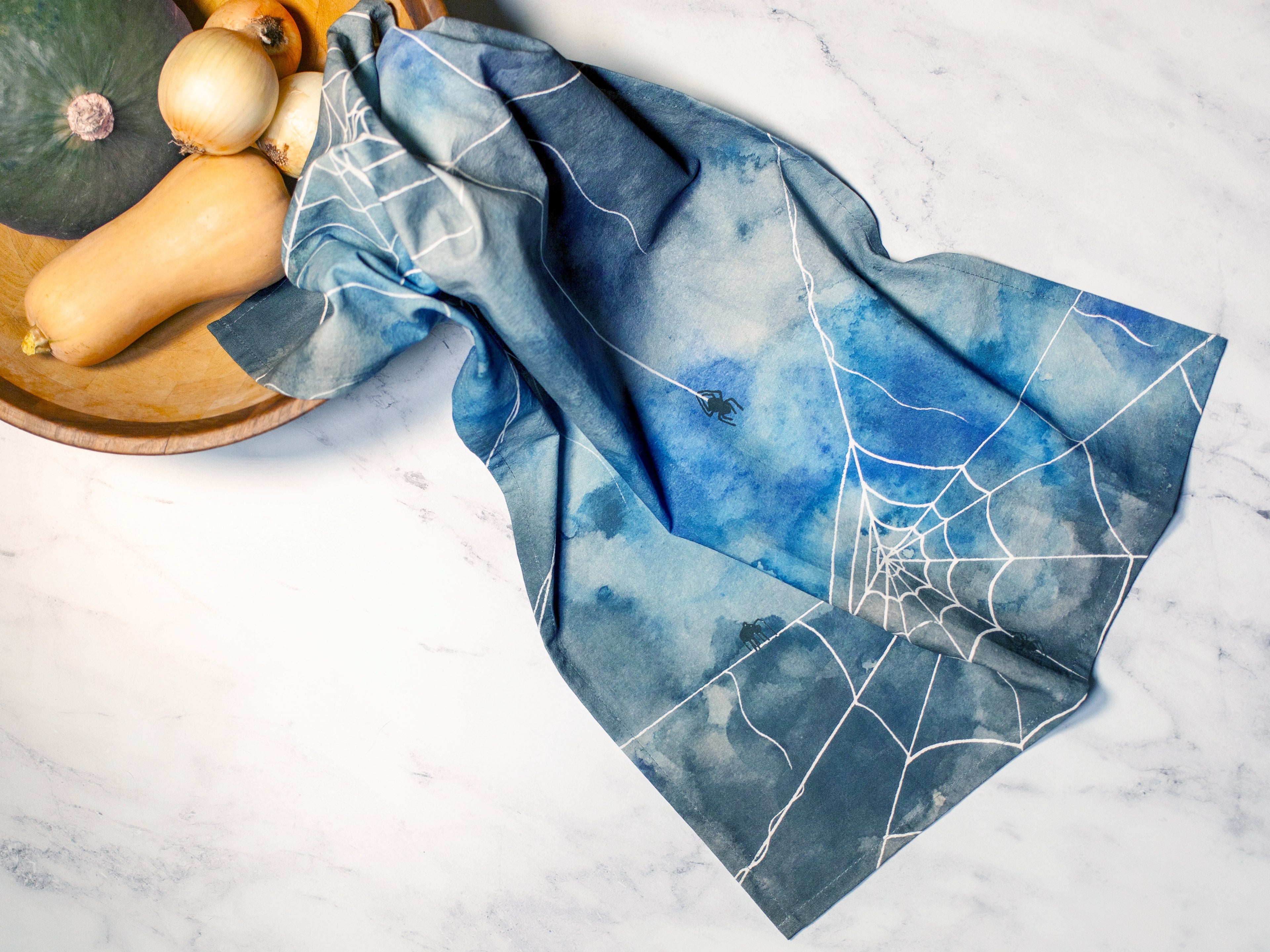 Blue fabric with spider web design on a white surface