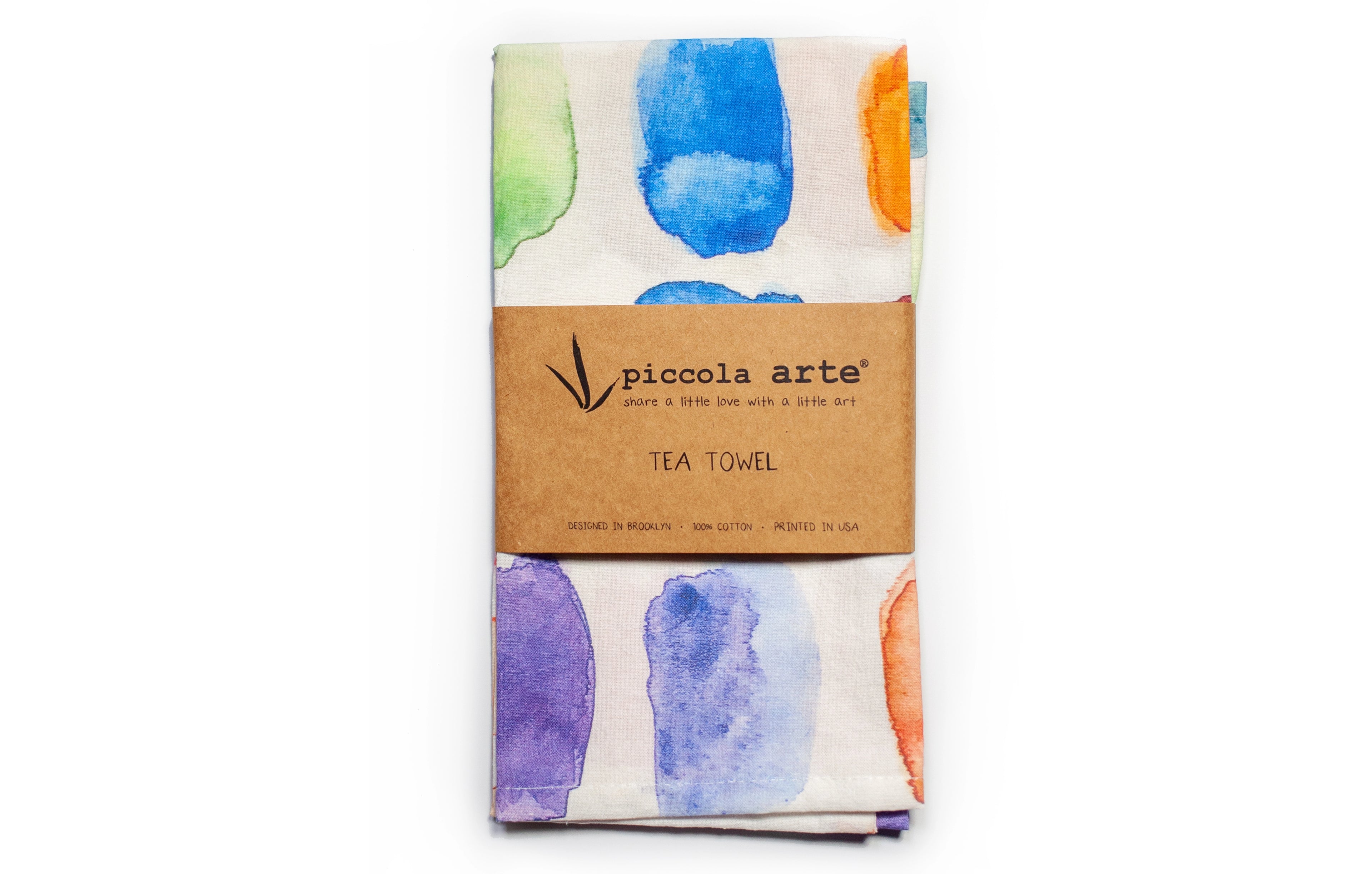 Tea towel with watercolor design and Piccola Arte branding on a white background