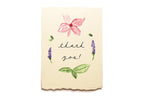 Note card with floral illustrations and 'thank you!' text on a white background