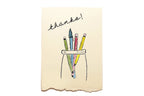 Card with colorful pencils in a bag and 'thanks!' text on a beige background