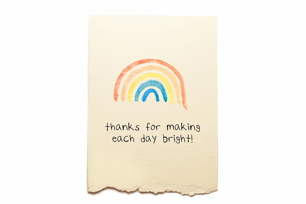 Note card with a rainbow and text on a white background