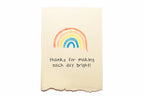 Note card with a rainbow and text on a white background