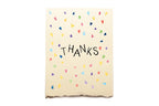 Notebook with 'THANKS' text and colorful shapes on a white background