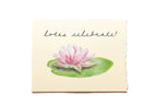 Note card with pink waterlily and 'lotus celebrate!' text on a beige background