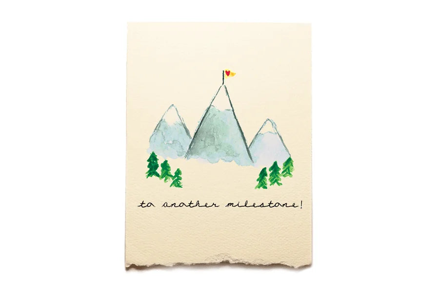 Card with mountain illustration and text 'to another milestone!' on a beige background