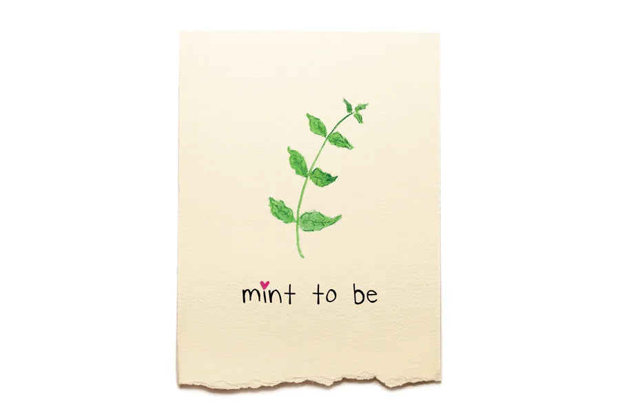 Beige towel with green leaf design and 'mint to be' text on a white background