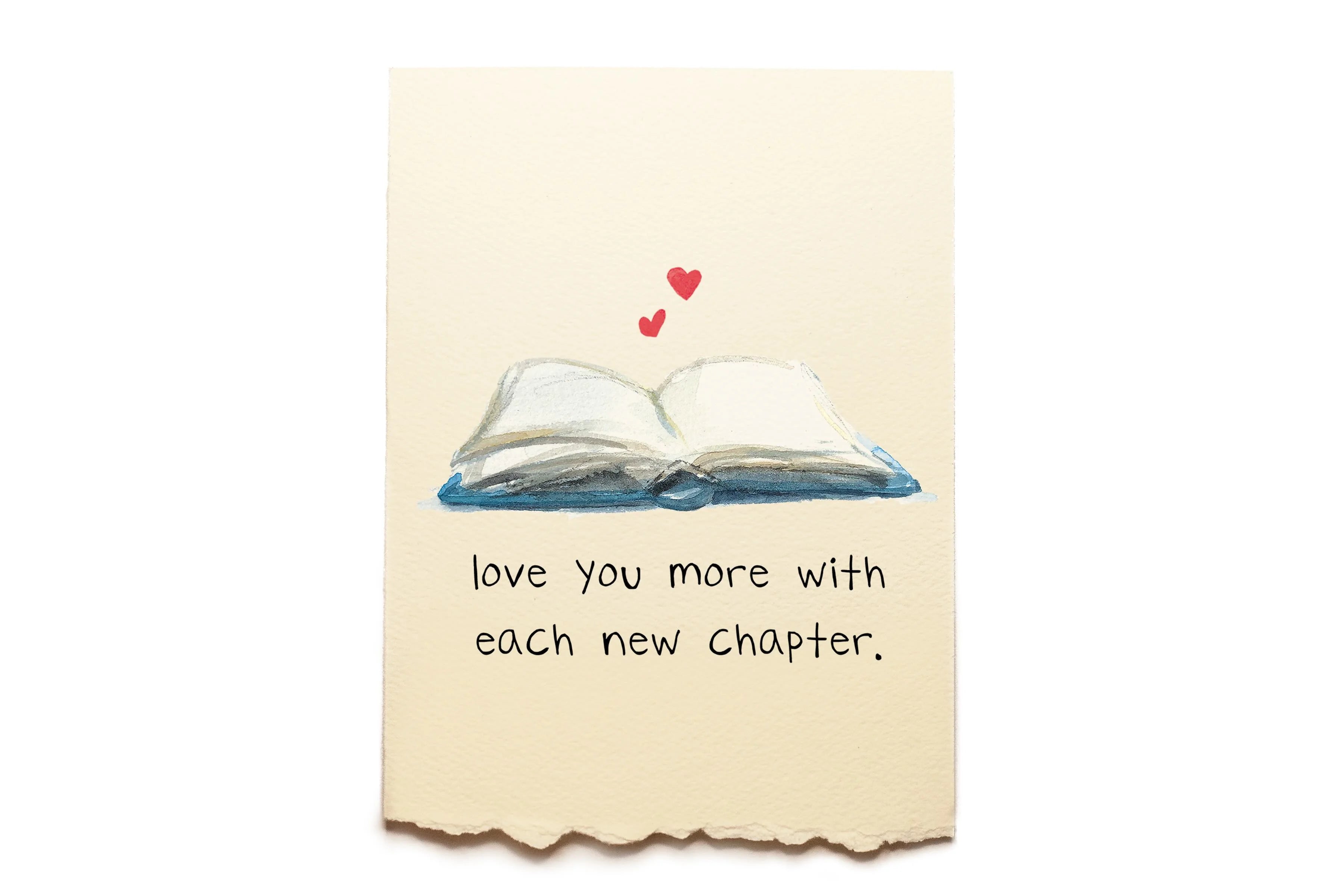 Card with an open book illustration and text 'love you more with each new chapter.' on a beige background.
